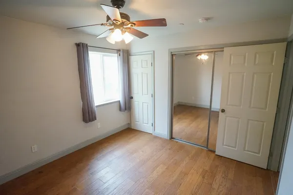 wooden floor in an empty room with a window
