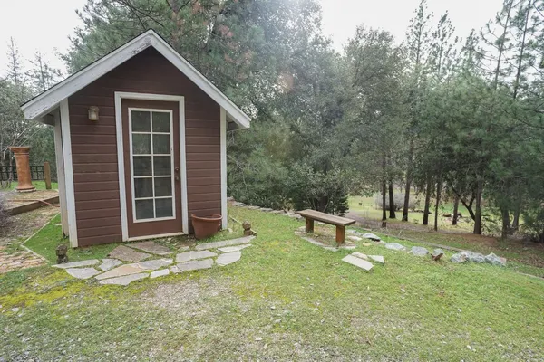a view of a house with a yard and sitting area
