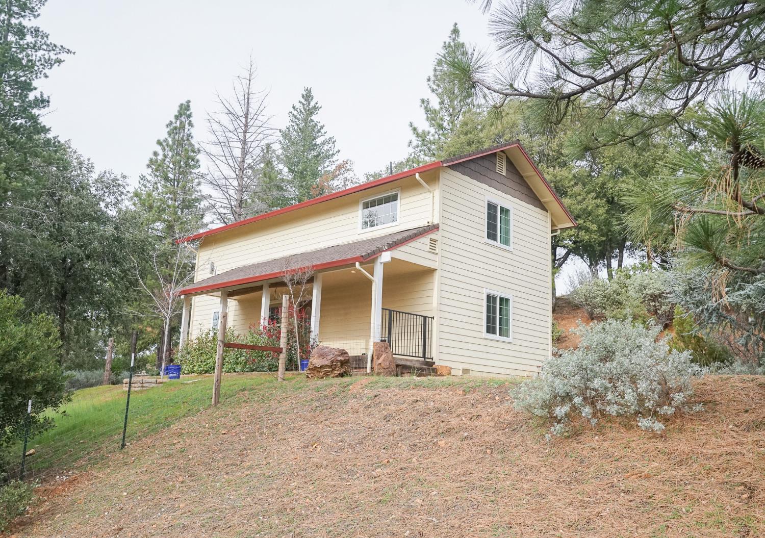 16375 Jesus Maria Road Mokelumne Hill, CA 95245 - Photo 3 of 39 a front view of a house with a porch