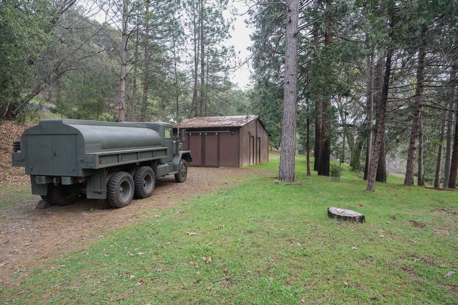 16375 Jesus Maria Road Mokelumne Hill, CA 95245 - Photo 32 of 39 a view of a house with backyard and trees