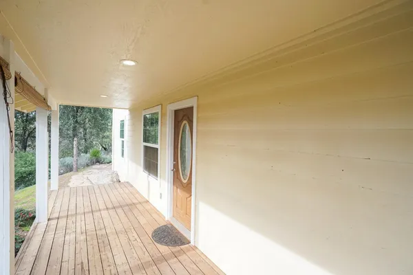 a view of a room with wooden floor and outdoor space