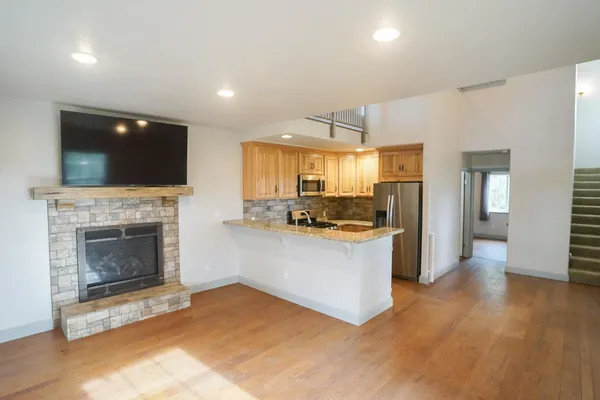 a kitchen with a refrigerator and a fireplace
