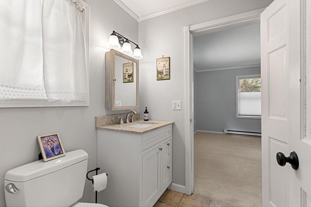 21 Hammond Street Rowley, MA 01969 - Photo 21 of 26 a bathroom with a granite countertop toilet sink and mirror