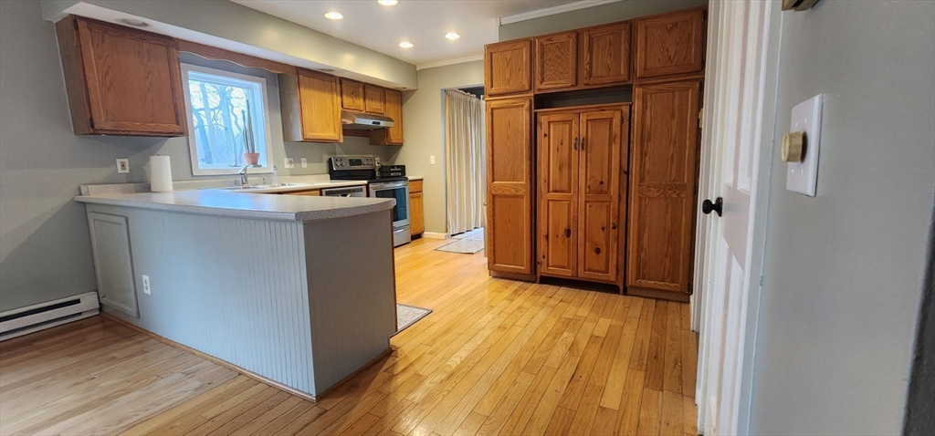 21 Hammond Street Rowley, MA 01969 - Photo 4 of 26 a kitchen with stainless steel appliances granite countertop a refrigerator a sink and wooden cabinets