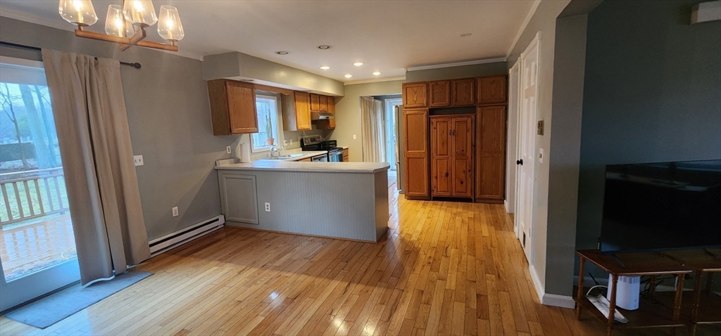 21 Hammond Street Rowley, MA 01969 - Photo 5 of 26 a view of kitchen with wooden floor electronic appliances and furniture