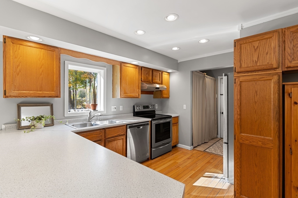 21 Hammond Street Rowley, MA 01969 - Photo 6 of 26 a kitchen with stainless steel appliances granite countertop a refrigerator and a sink