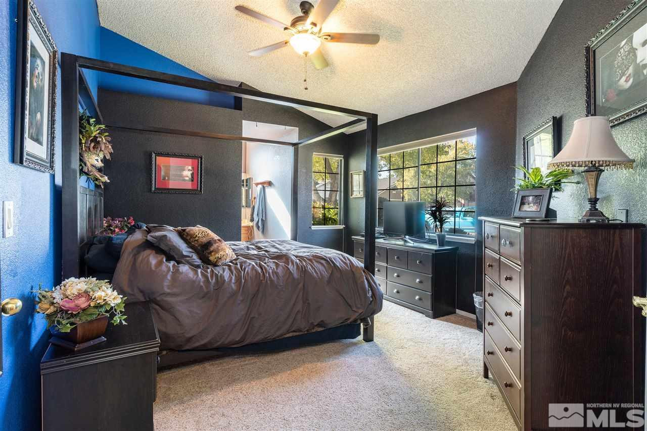 1030 Backer Way Reno, NV 89523 - Photo 13 of 25 a bed room with a bed and a chandelier