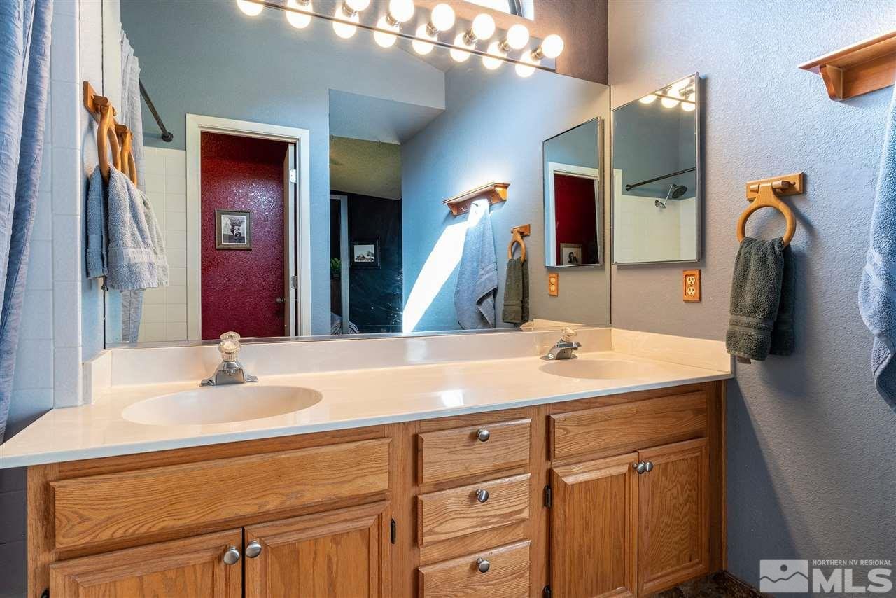 1030 Backer Way Reno, NV 89523 - Photo 14 of 25 a bathroom with a sink vanity and a mirror