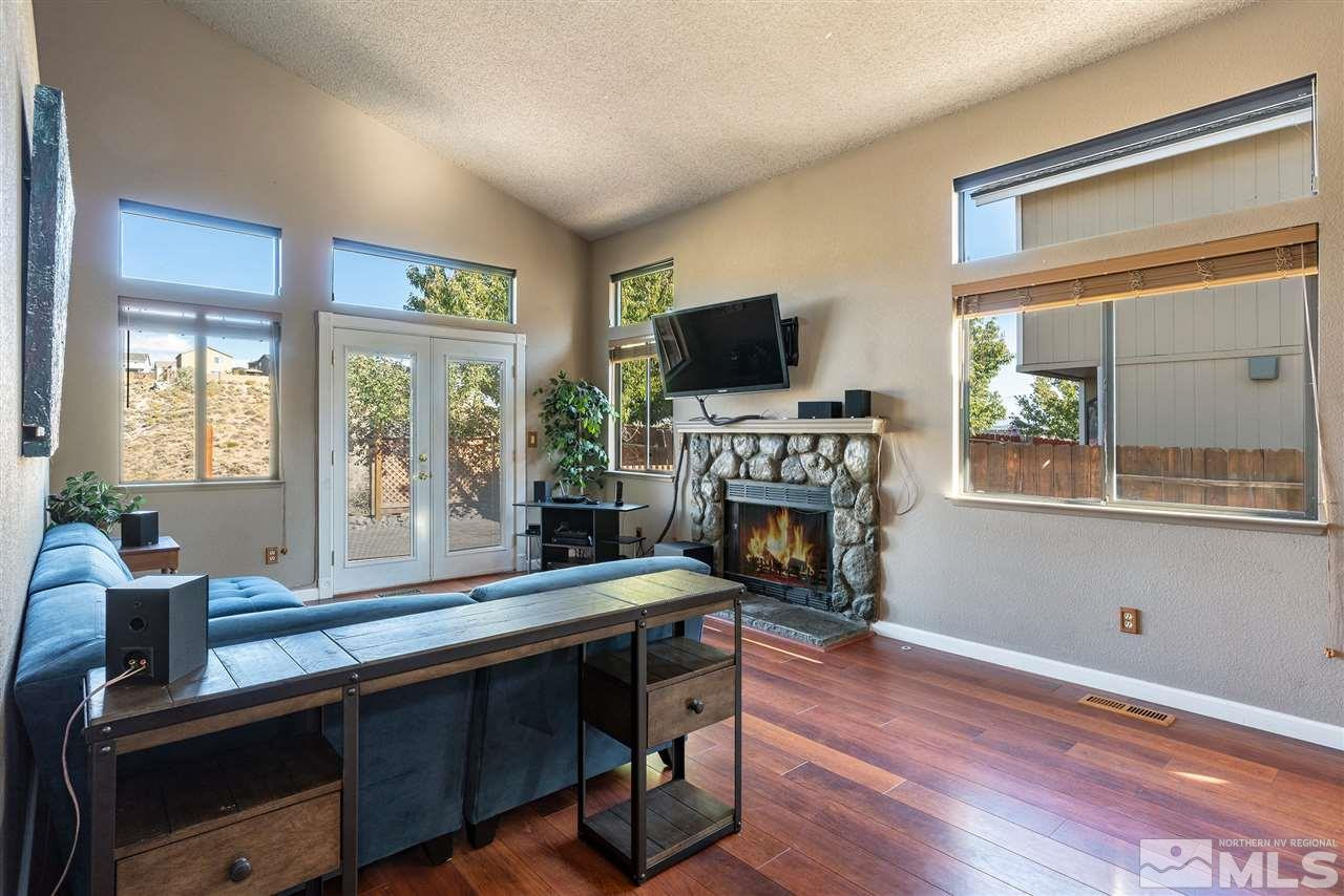 1030 Backer Way Reno, NV 89523 - Photo 4 of 25 a living room with furniture a fireplace and a flat screen tv