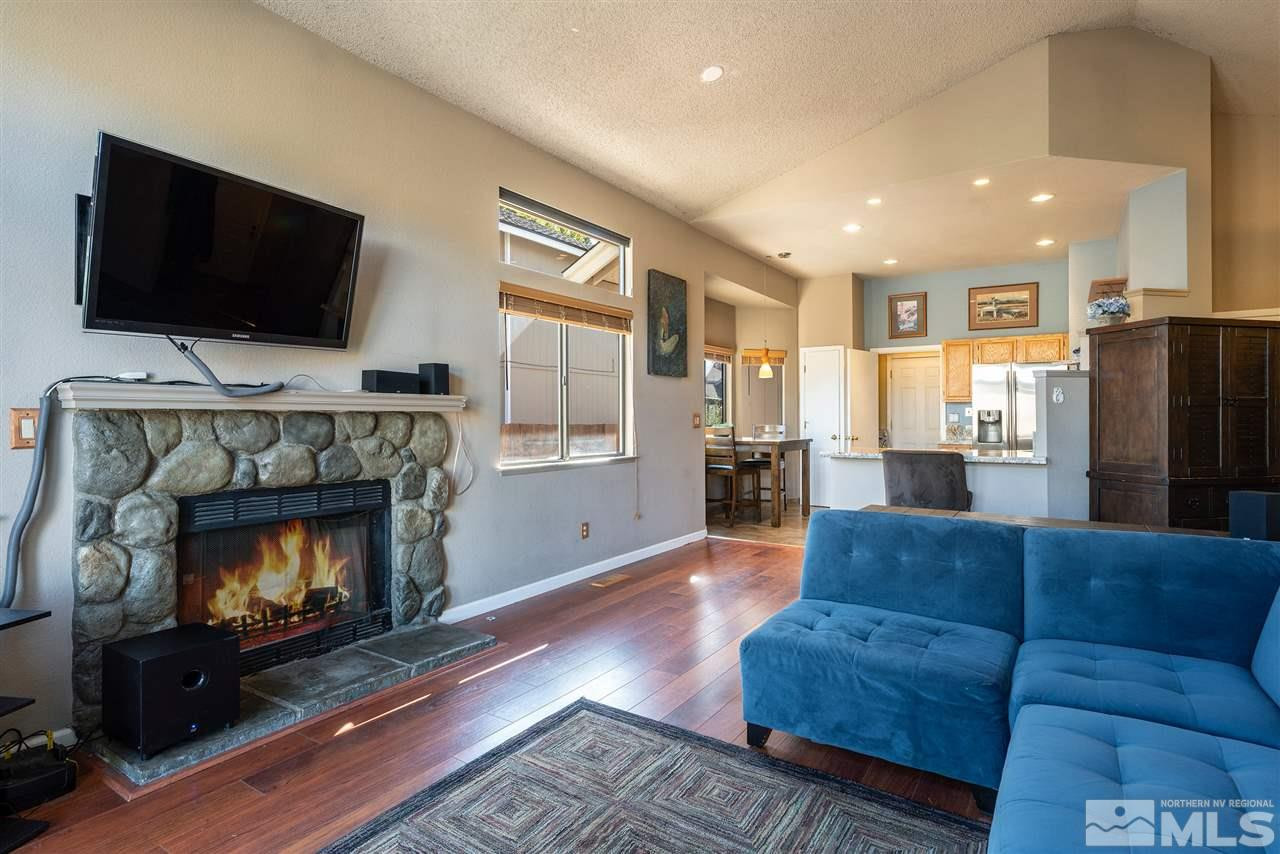 1030 Backer Way Reno, NV 89523 - Photo 7 of 25 a living room with furniture a flat screen tv and a fireplace