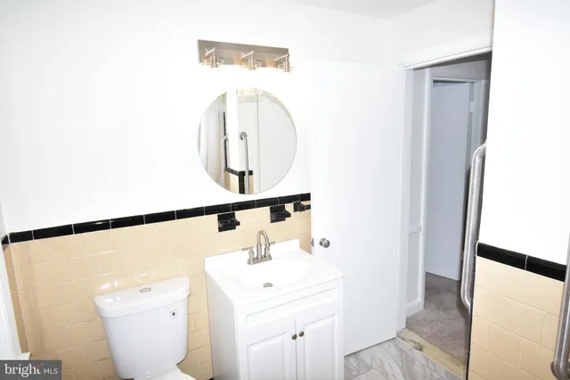 a bathroom with a sink a toilet and a mirror