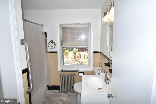 a bathroom with a sink a window and a mirror