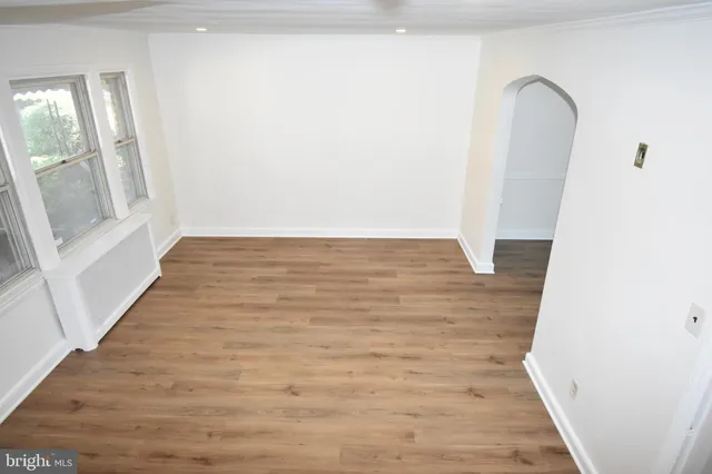 a view of a room with wooden floor and white walls