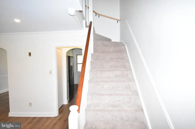 a view of staircase with white walls