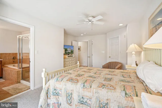 a bathroom with a tub a sink and mirror