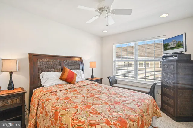 a bedroom with a bed dresser and a window