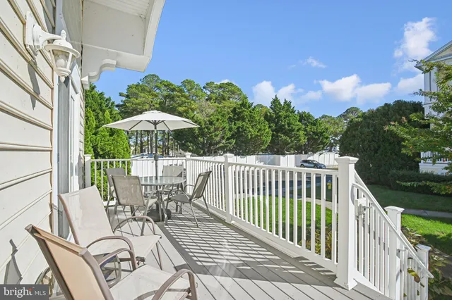 a view of balcony with wooden floor and outdoor seating
