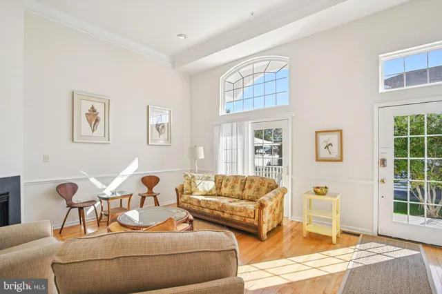 a living room with furniture chess table and a window