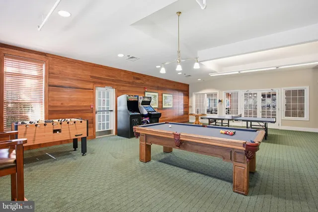 a dining room with furniture a rug and a large window