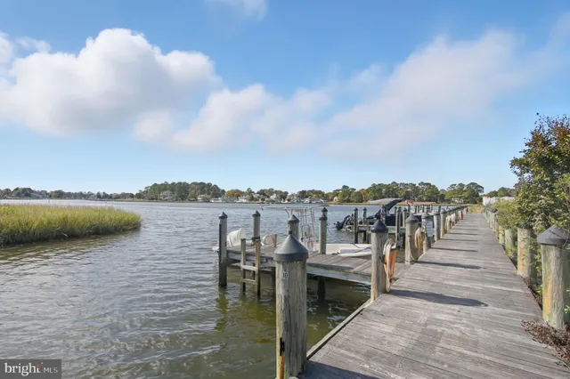 a view of a lake with a table and chairs