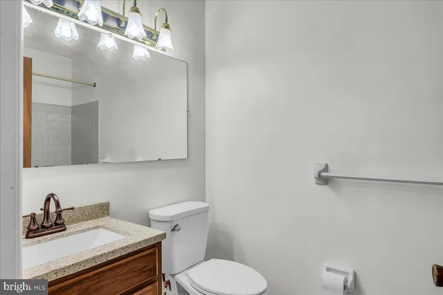 a bathroom with a sink vanity and a toilet