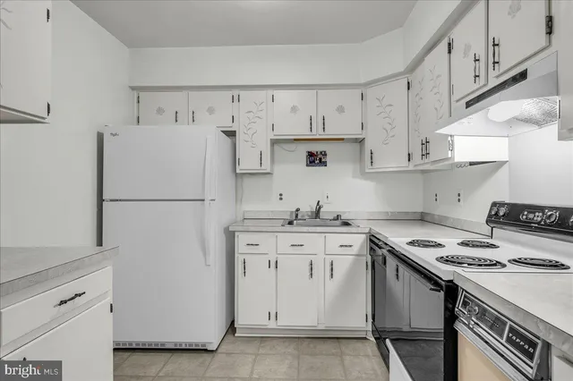 a kitchen with a white cabinets and white appliances