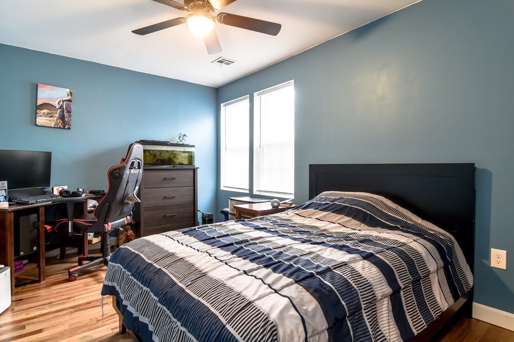 514 Edgell Road Framingham, MA 01701 - Photo 25 of 35 a bedroom with a bed and a chandelier
