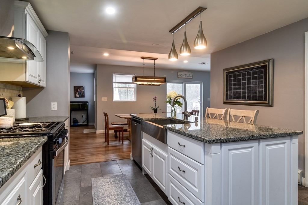 514 Edgell Road Framingham, MA 01701 - Photo 3 of 35 a kitchen with stainless steel appliances granite countertop lots of counter top space and wooden floor