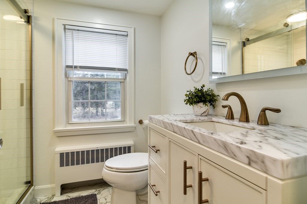 514 Edgell Road Framingham, MA 01701 - Photo 31 of 35 a bathroom with a sink and a mirror