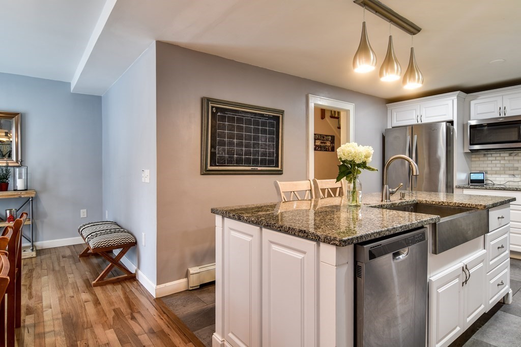514 Edgell Road Framingham, MA 01701 - Photo 4 of 35 a kitchen with stainless steel appliances granite countertop a sink stove and refrigerator