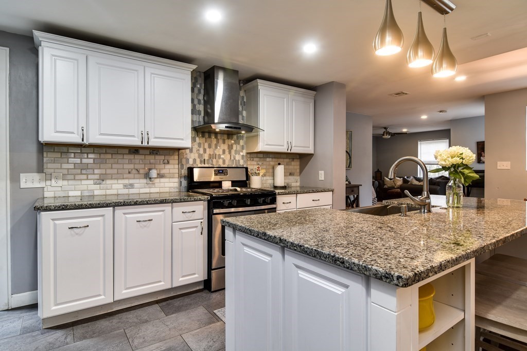 514 Edgell Road Framingham, MA 01701 - Photo 5 of 35 a kitchen with stainless steel appliances granite countertop a sink stove and cabinets