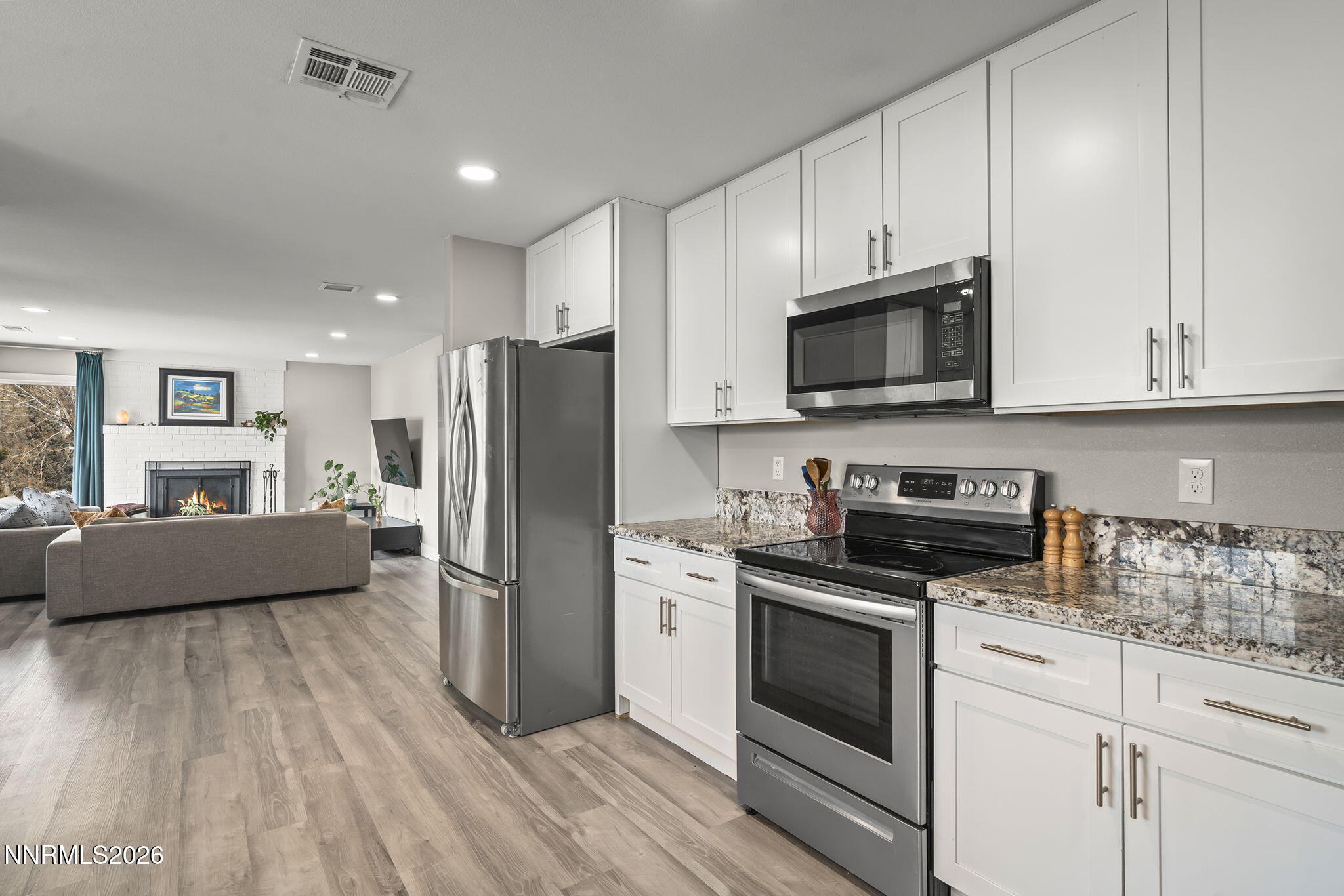 150 Mayberry Drive Reno, NV 89509 - Photo 12 of 40 a kitchen with stainless steel appliances a stove a refrigerator sink and cabinets