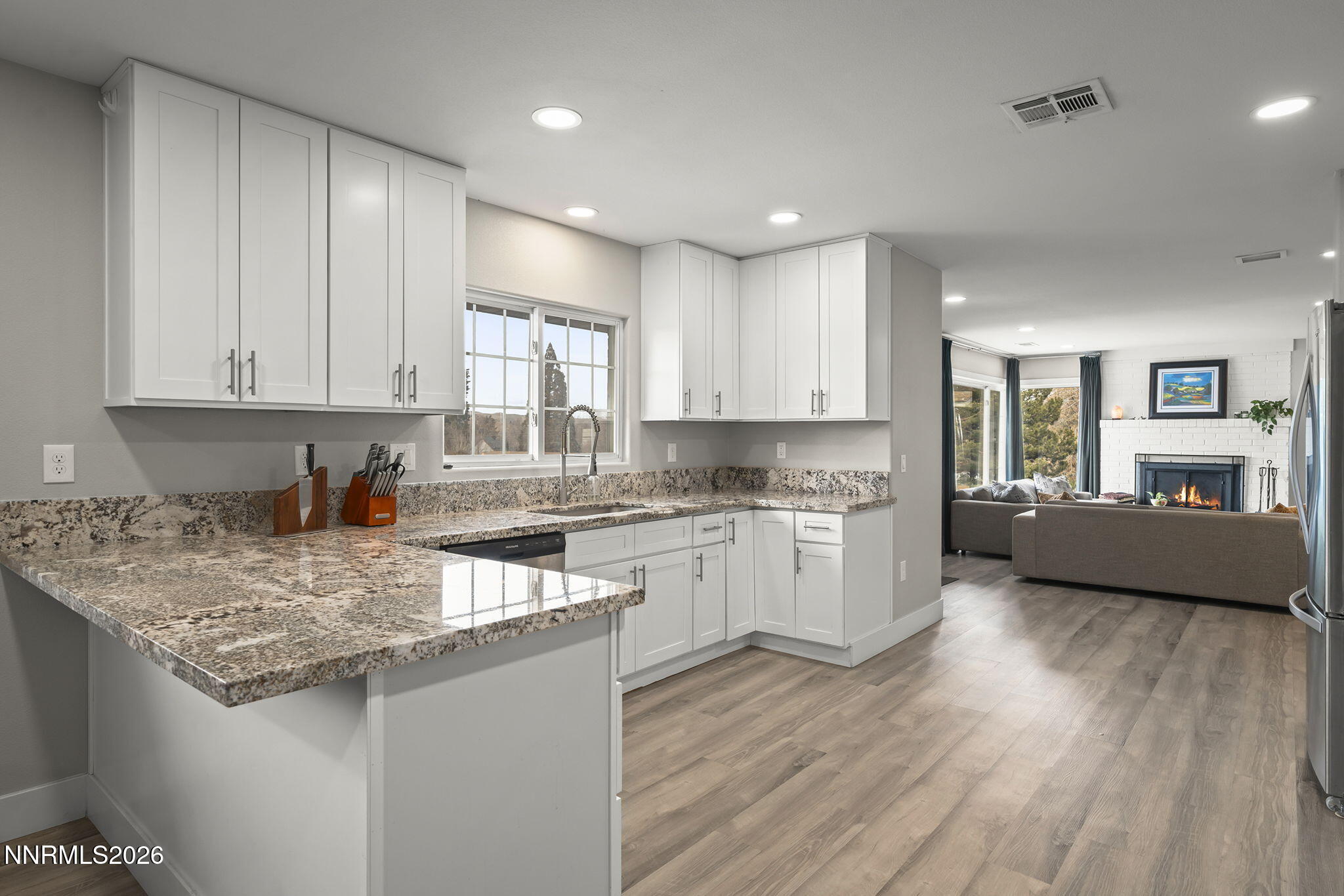 150 Mayberry Drive Reno, NV 89509 - Photo 13 of 40 a kitchen with granite countertop a sink cabinets and wooden floor