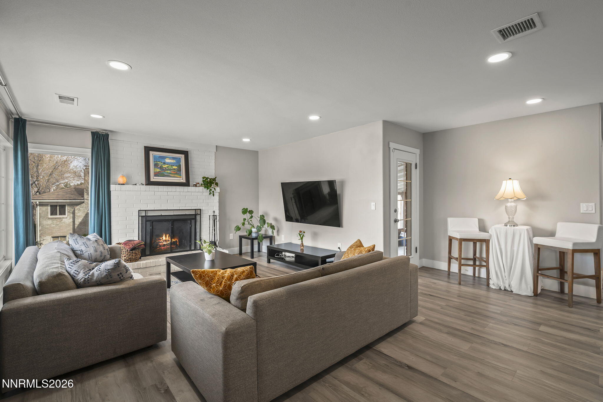 150 Mayberry Drive Reno, NV 89509 - Photo 15 of 40 a living room with furniture a fireplace and a flat screen tv