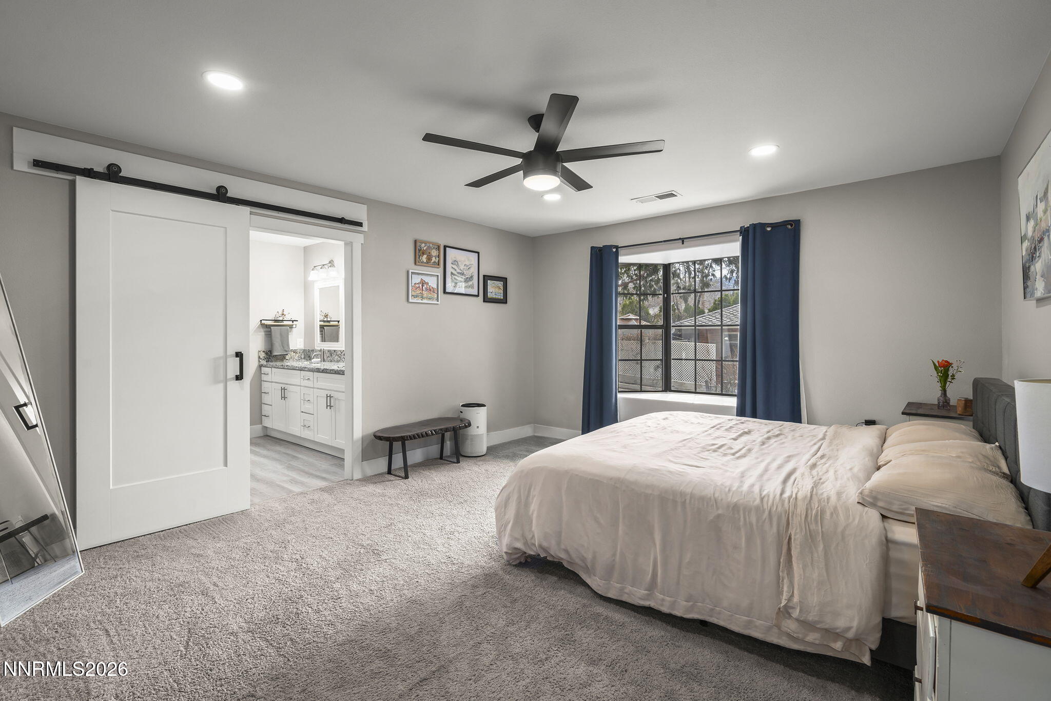 150 Mayberry Drive Reno, NV 89509 - Photo 17 of 40 a bedroom with a large bed and a chandelier