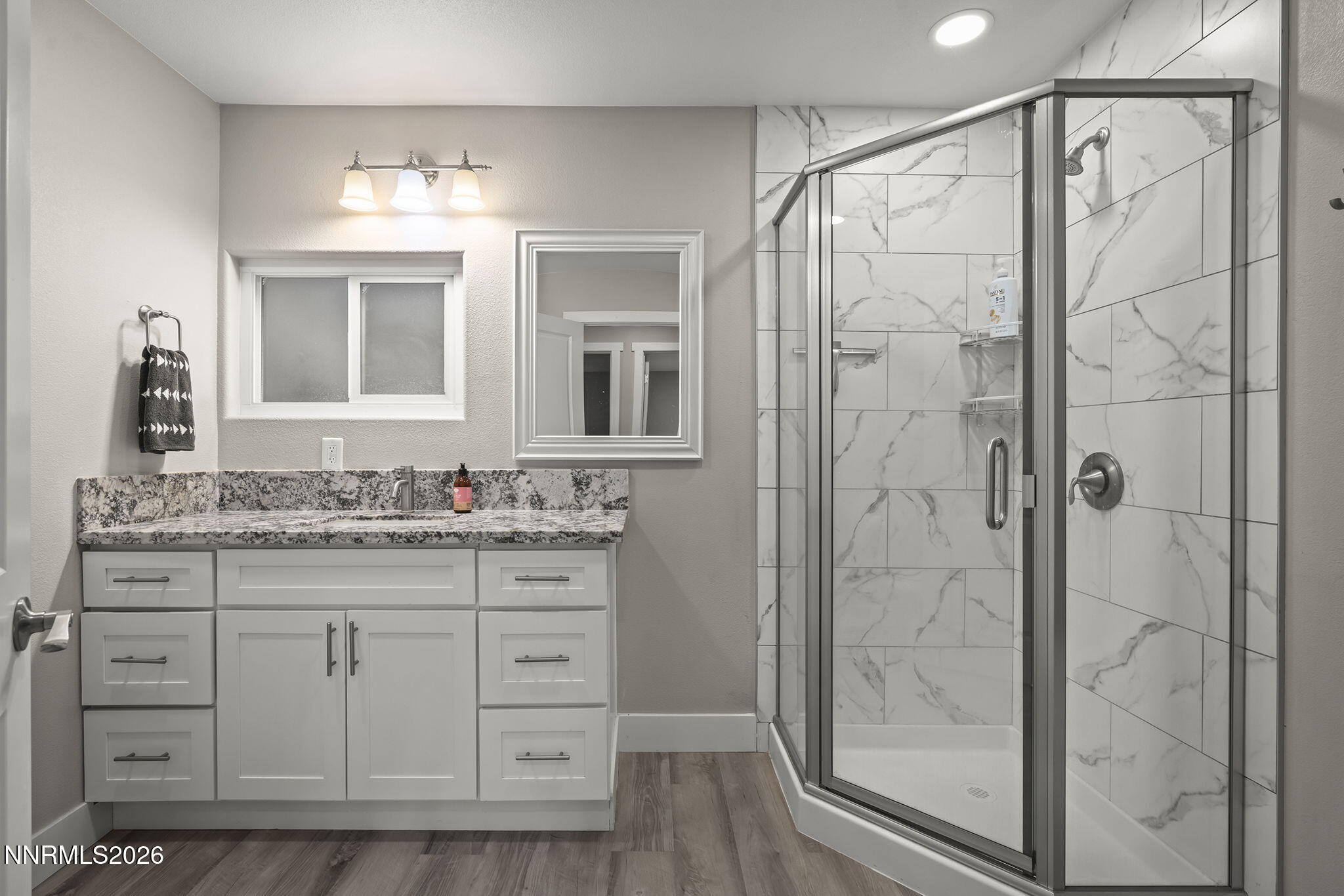 150 Mayberry Drive Reno, NV 89509 - Photo 23 of 40 a bathroom with a granite countertop sink a mirror and shower