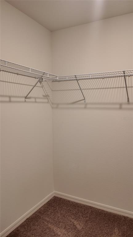 2798 Raindrop Run Street Clermont, FL 34714 - Photo 11 of 18 a view of a room with racks on the wall