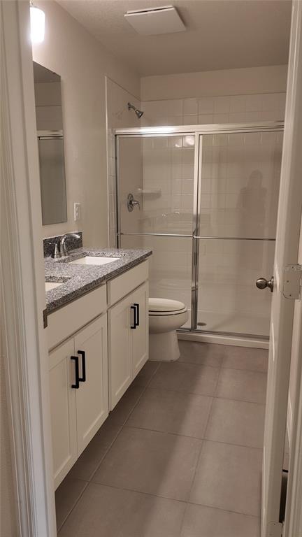 2798 Raindrop Run Street Clermont, FL 34714 - Photo 15 of 18 a bathroom with a granite countertop sink a toilet and shower