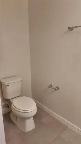 a white toilet sitting next to a shower