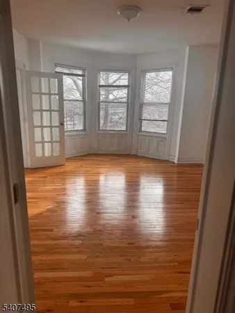 wooden floor in an empty room with window
