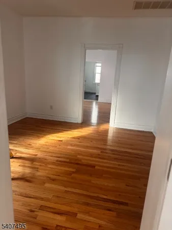 a view of room with wooden floor