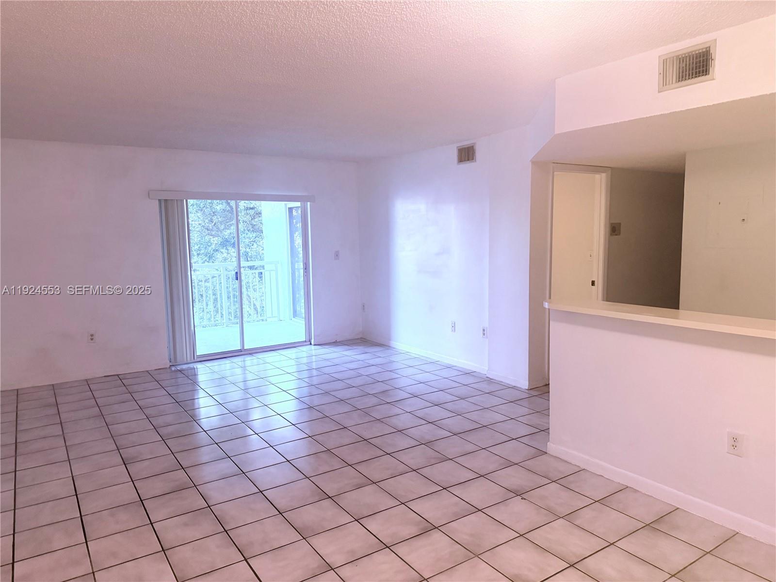 8540 Southwest 212th Street, Unit 308 Cutler Bay, FL 33189 - Photo 1 of 8 a view of an empty room and window
