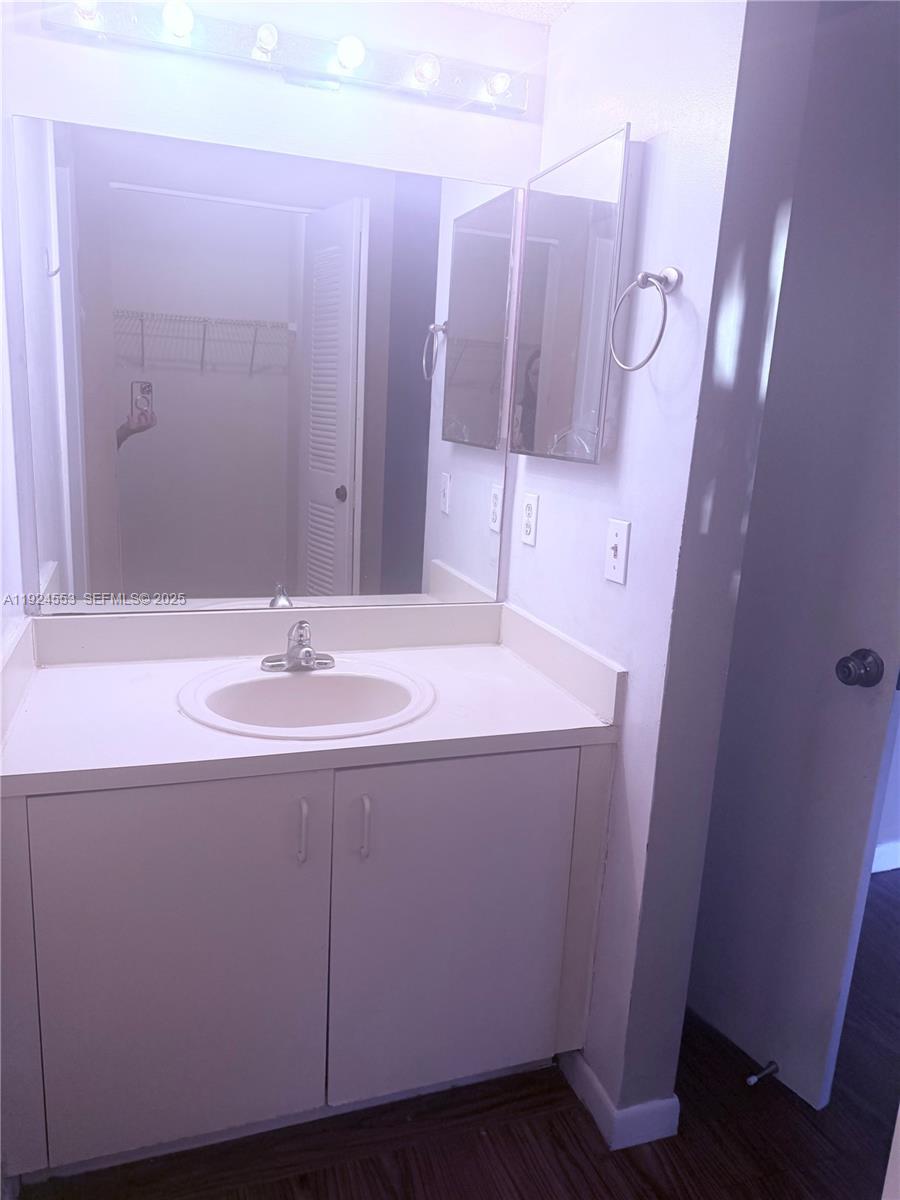 8540 Southwest 212th Street, Unit 308 Cutler Bay, FL 33189 - Photo 6 of 8 a bathroom with a sink and a mirror