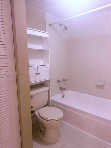 a bathroom with a toilet a sink and bathtub