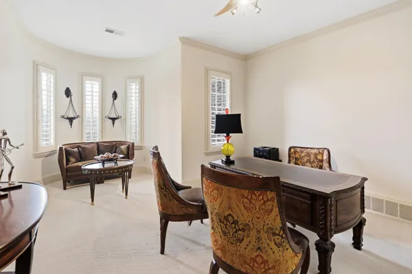 a view of a dining room with furniture a chandelier and wooden floor