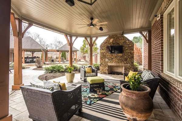 a living room with furniture a fireplace and a floor to ceiling window