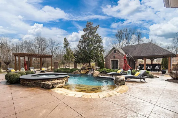 an aerial view of residential houses with outdoor space and parking