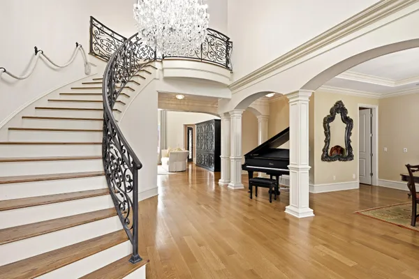 a view of entryway and hall with wooden floor