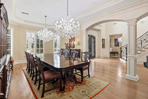 a view of a dining room with furniture and chandelier