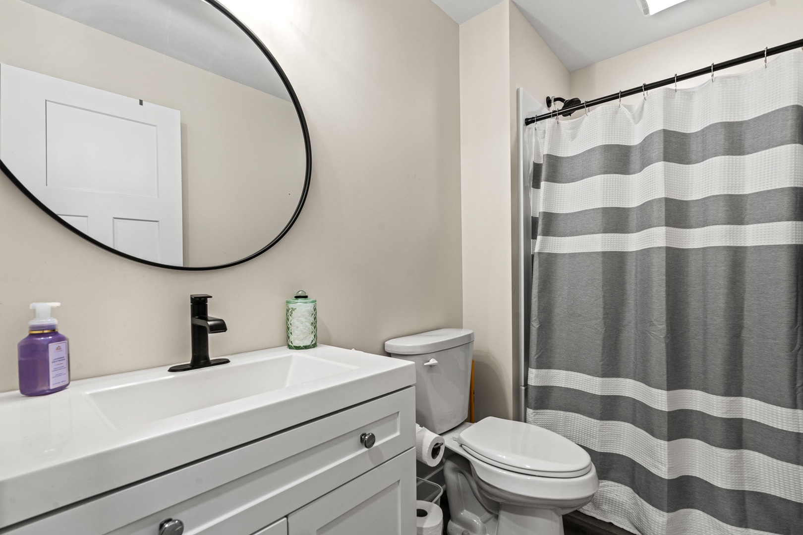 1598 Elder Drive Aurora, IL 60506 - Photo 18 of 22 a bathroom with a sink a toilet a mirror and shower curtain